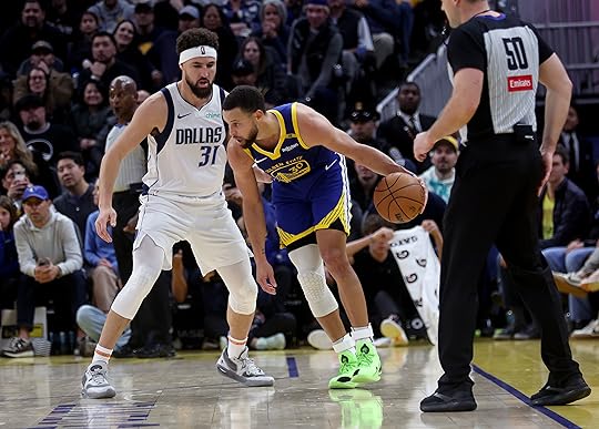 Golden State Warriors’ Stephen Curry #30 is guarded by Dallas...