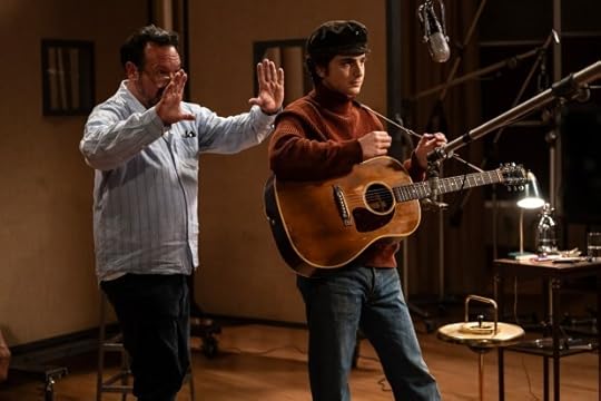 James Mangold gestures behind Timothée Chalamet.
