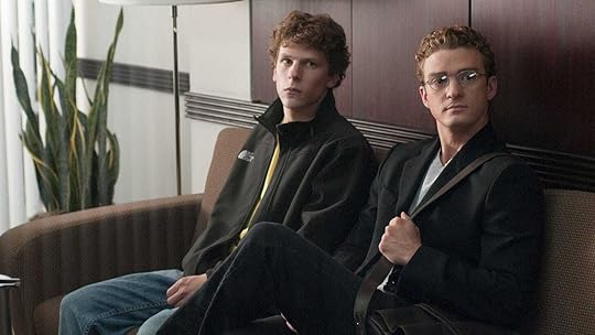 Jesse Eisenberg and Justin Timberlake sit on a couch in