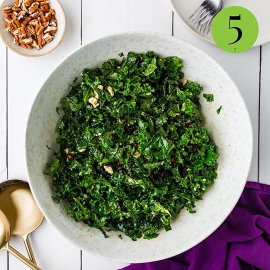 mixture of kale salad with pomegranates in bowl