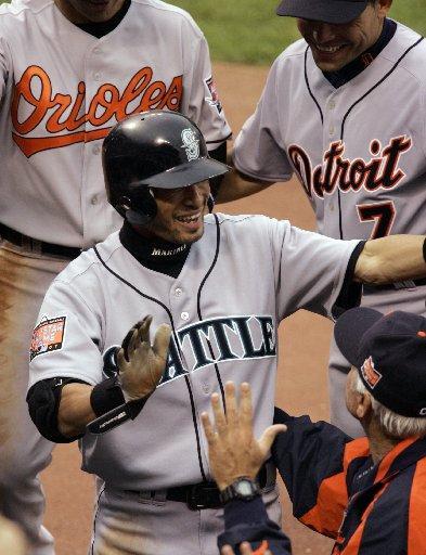 American League's Ichiro Suzuki, of the Seattle Mariners, celebrates his two run inside the park home run in the fifth inning of the All-Star baseball game.