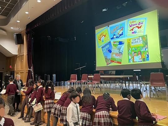 Joyce Grant signing autographs for grade 5 students