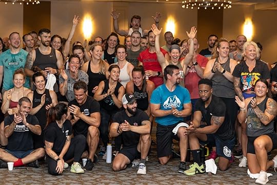 A group of smiling gym owners pose after a workout at the Two-Brain Summit.