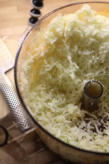 Shredded cabbage in a food processor bowl for health salad.