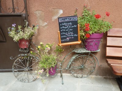 photo of old bicycle in Provence bearing pots of geraniums 