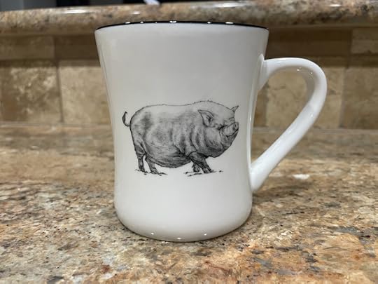 Picture of a coffee mug with a drawing of a pig