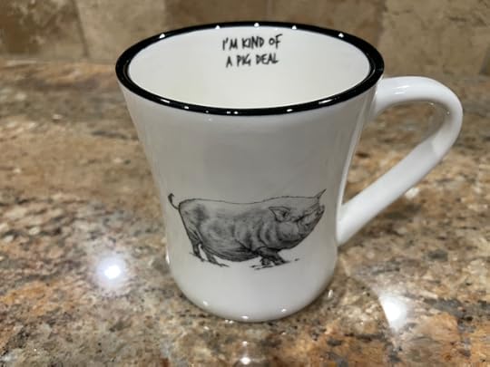 Picture of a coffee mug with a drawing of a pig and writing on the inside surface