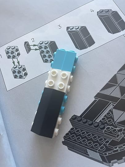 LEGO Blue and White bricks being covered by black