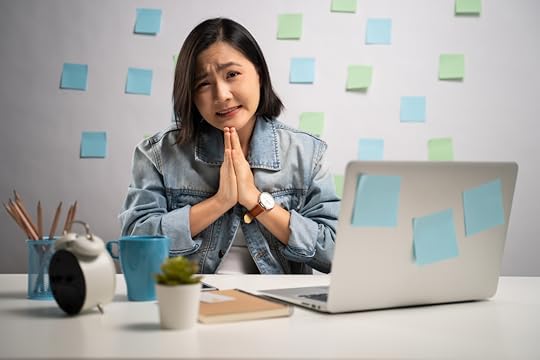 Woman working from home, hands together asking for foregiveness