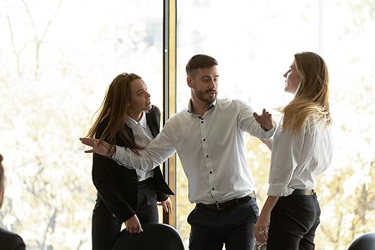 Man getting in between two fighting colleagues