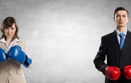 Two people in suits wearing boxing gloves