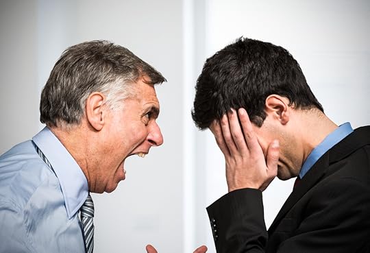 Boss yelling at a person who has his head in his hands