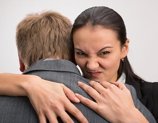 Person hugging colleague but with an evil expression
