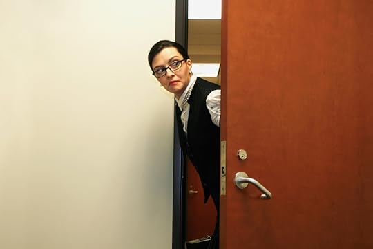 person sneaking around an office