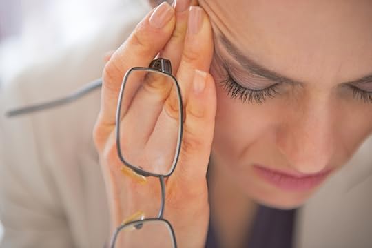 person rubbing their temples in distress