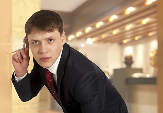 Person using glass to listen at a door