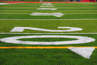Image of ground-level view of a football field's painted numbers