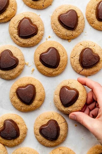 hand holding a peanut butter Valentine's Day cookie.