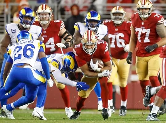 San Francisco 49ers' Isaac Guerendo (31) turns with the ball against Los Angeles Rams' Kamren Kinchens (26) and Los Angeles Rams' Jaylen McCollough (39) in the fourth quarter at Levi's Stadium in Santa Clara, Calif., on Thursday, Dec. 12, 2024. (Shae Hammond/Bay Area News Group)