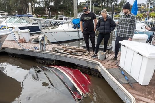 Sean Varenkamp, right, checks out what's left of his capsized 26-foot Ranger tugboat, Thursday, Dec. 26, 2024, in the Santa Cruz Harbor. The boat was among those damaged in the Dec. 23 storm. (Karl Mondon/Bay Area News Group)