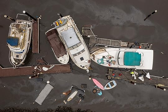 People pump water out of a boat in Santa Cruz...
