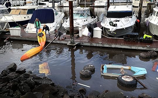 People salvage kayaks at the harbor on Tuesday. (Shmuel Thaler...