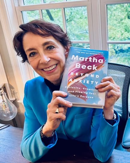 Martha smiling holding Beyond Anxiety book
