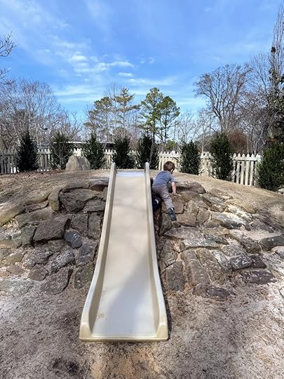 a boy playing on a slide