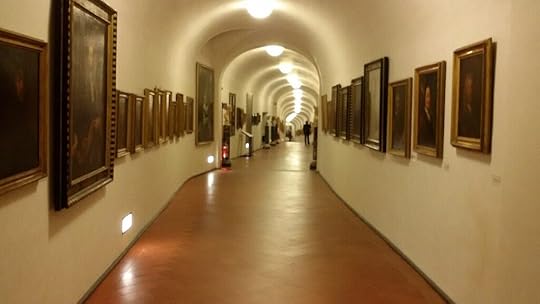 Continuation of the ramp, you can see it bending and sloping downward in segments as it bends. The ceiling is now arched. Paintings still line both walls.