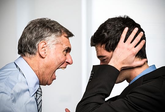 One colleague yelling at another while the receiver covers his ears with his hands.