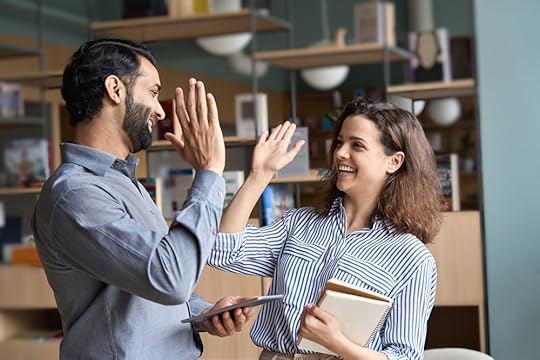 Two colleagues giving each other a high five