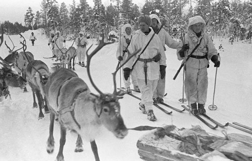 Finnish soldiers on skis with reindeer, near Jäniskoski, Finland, 20 Feb 1940 (Finnish Army Picture, public domain via Wikipedia)
