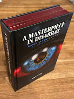 Photograph showing the hardback book "A Masterpiece in Disarray - David Lynch's Dune an oral history", by Max Evry, with red edge-painting on pages and a cover showing a close-up of an eye on a spacey, sci-fi background