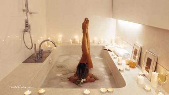 Woman having a sensual, romantic bath with wine and candles