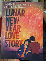 Cover of Lunar New Year Love Story by Gene Luen Yang and Leuyen Pham, showing young couple canoodling beneath stars that contain a Chinese lion