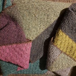 photo of knitted blanket folded to show array of colours