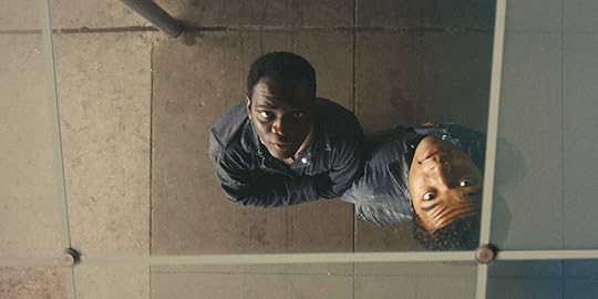 Ethan Herisse and Brandon Wilson look at their reflections in a bus station ceiling in