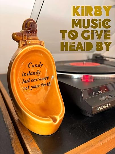 Candy dish in the shape of a urinal besides a turntable with the words Kirby Music To Give Head By