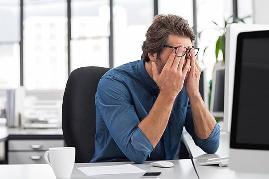 Image of a stressed man sitting in an office covering his face. With the support of an adult IOP in Houston, TX you can begin coping with your anxiety symptoms in positive ways.
