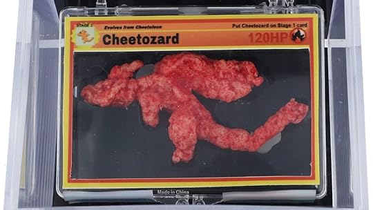 A Charizard shaped Cheeto in a plastic box.