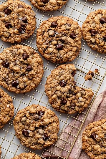 oatmeal chocolate chip cookies on gold cooling rack.