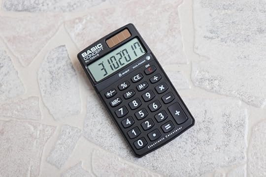 Black calculator on grey stone background