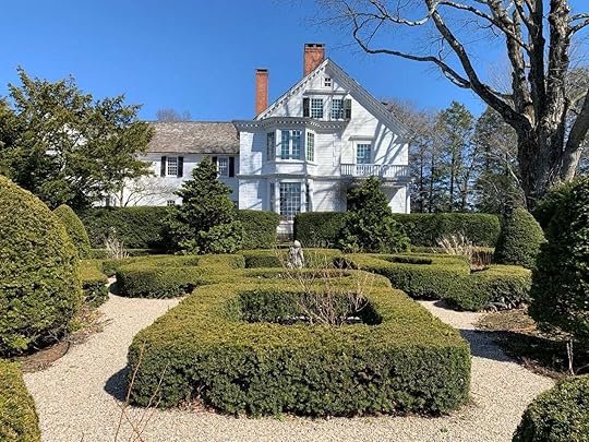 A house with a garden and bushesDescription automatically generated