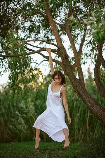 Current image: woman in white dress hanging from a tree outdoors