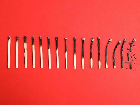 row of burnt matches on a red background