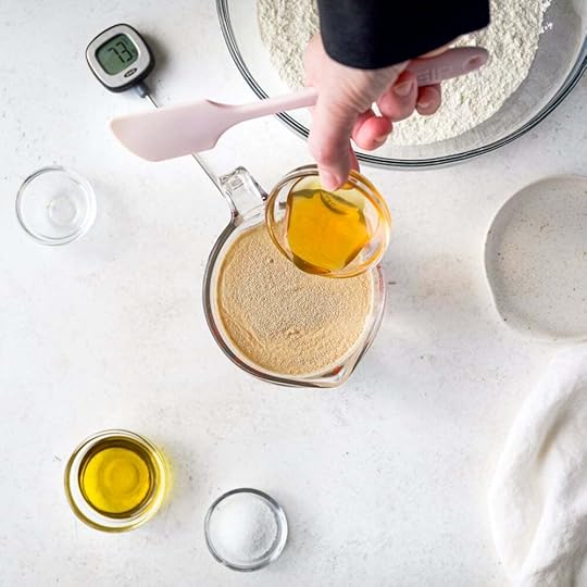 Pouring honey into water and store-bought yeast.