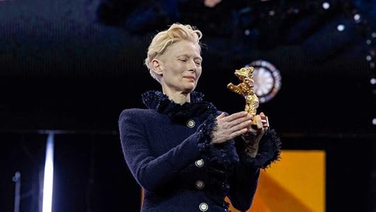 A person holding a gold bearAI-generated content may be incorrect.