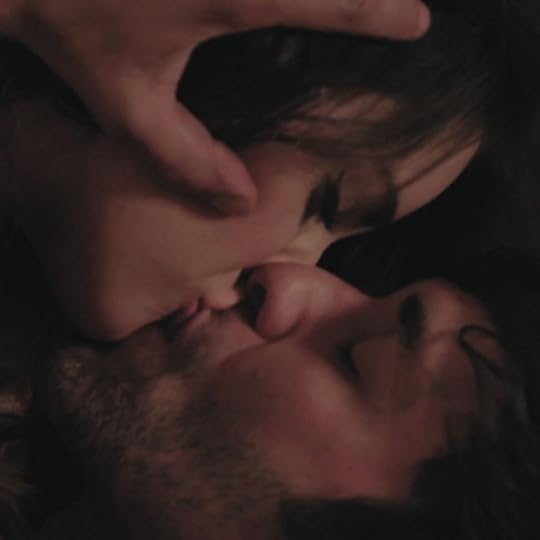 This may contain: a man and woman laying next to each other