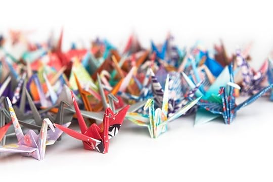 a colorful array of origami folded paper cranes