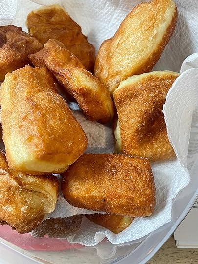 Jumble of Fastnachts of varying brown hues on while paper towel.